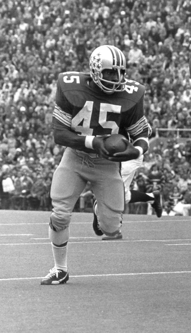 Ohio State football player running with the football in a photograph from the 1970s.